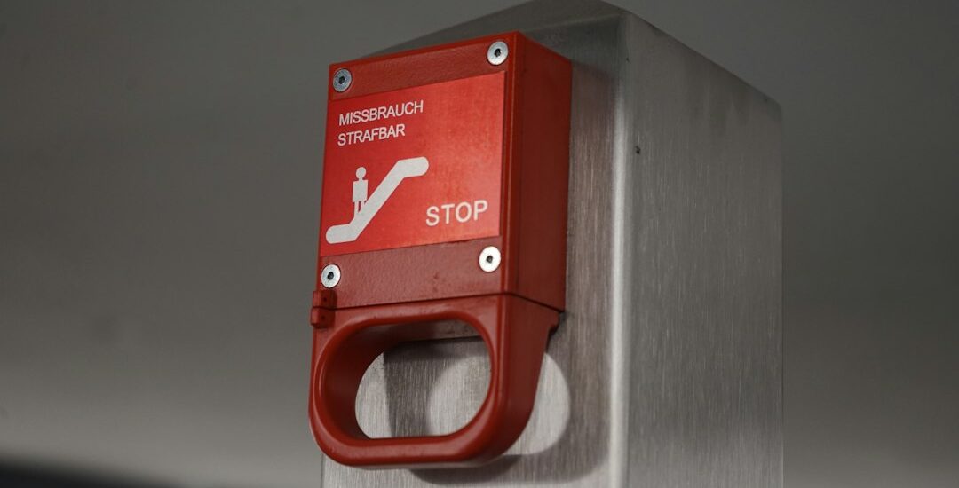 Emergency stop button representing AI governance and runtime containment for autonomous agents